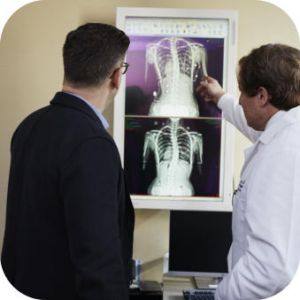 Image of man talking with physician about xrays - click to read about the mini-internship