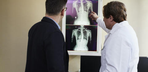 Image of man looking at xrays with a physician